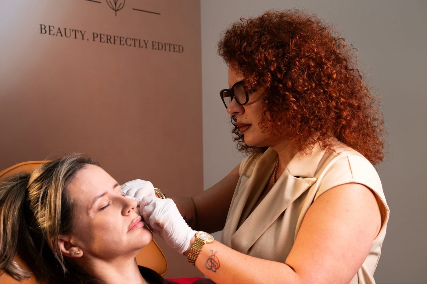 Beatriz Duque, APRN, performing a facial injection herself at The Edit